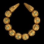 Cat. No. 143: Necklace (Tillya Tepe, Tomb VI), 1st century BC - 1st century AD, gold and turquoise, length of long bead: 5 cm(2); diameter of long bead: 2.2 cm (7/8); length of round bead: 2.7 cm (1 1/ 16);  diameter of round bead: 2.6 cm (1)  - National Museum of Afghanistan © Thierry Ollivier / Musée Guimet